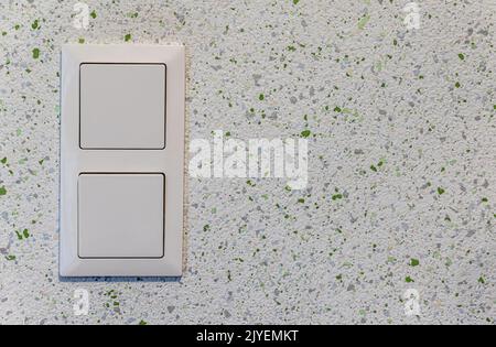 Light switch on an interior wall with speckled wall design with spray paint Stock Photo