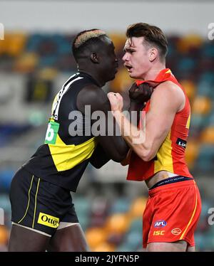 Mabior Chol (left) of the Tigers grapples with Caleb Graham (right) of the  Suns during the Round 12 AFL match between the Richmond Tigers and Gold  Coast Suns at the Gabba in