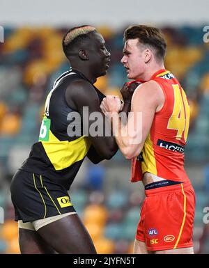 Mabior Chol (left) of the Tigers grapples with Caleb Graham (right) of the  Suns during the Round 12 AFL match between the Richmond Tigers and Gold  Coast Suns at the Gabba in