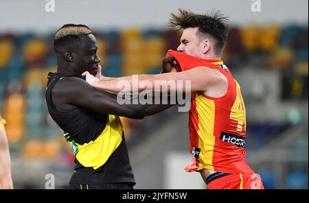 Mabior Chol (left) of the Tigers grapples with Caleb Graham (right) of the  Suns during the Round 12 AFL match between the Richmond Tigers and Gold  Coast Suns at the Gabba in