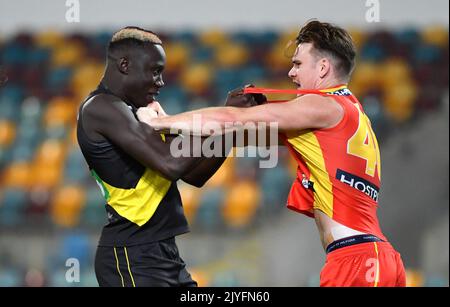 Mabior Chol (left) of the Tigers grapples with Caleb Graham (right) of the  Suns during the Round 12 AFL match between the Richmond Tigers and Gold  Coast Suns at the Gabba in