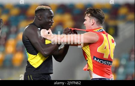 Mabior Chol (left) of the Tigers grapples with Caleb Graham (right) of the  Suns during the Round 12 AFL match between the Richmond Tigers and Gold  Coast Suns at the Gabba in