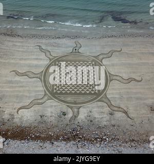Different layers of sand create the 3D effect. Ireland, UK: FROM PSYCHEDELIC patterns to a giant-sized pooch-portraits these are the best of sand art Stock Photo