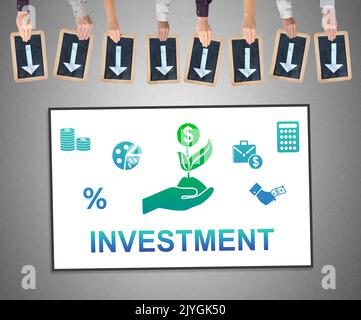 Hands holding writing slates with arrows pointing on investment concept Stock Photo