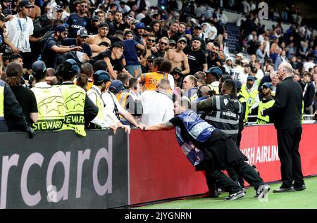 London, UK. 7th Sep, 2022. Stewards hold back Olympique de Marseille fans as one tries to jump towards the pitch from the stands after the UEFA Champions League Group D match at the Tottenham Hotspur Stadium, London. Picture credit should read: Paul Terry/Sportimage Credit: Sportimage/Alamy Live News Stock Photo
