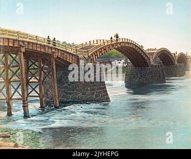 Japan: Kintai Bashi or Soroban Bashi, Iwakuni, Yamaguchi Prefecture. Photo by Kusakabe Kimbei (1841-1934), c. 1880-1899. The Kintai Bridge is a historical wooden arch bridge, in the city of Iwakuni, in Yamaguchi Prefecture. The bridge was built in 1673, spanning the Nishiki River in a series of five wooden arches, and the bridge is located on the foot of Mount Yokoyama, at the top of which lies Iwakuni Castle. Declared a National Treasure in 1922, Kikkou Park, which includes the bridge and castle, is one of the most popular tourist destinations in Japan. Stock Photo