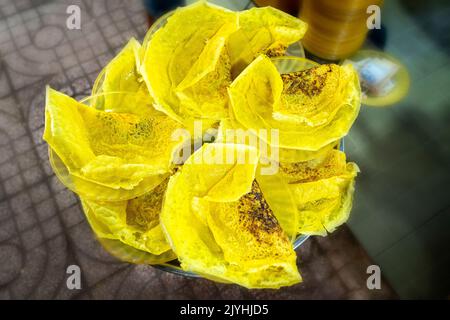 Vietnam food, banh xeo or vietnamese pancakes being fried under hot coals, they are made with rice flour and filled with a soya bean sprouts, is popul Stock Photo