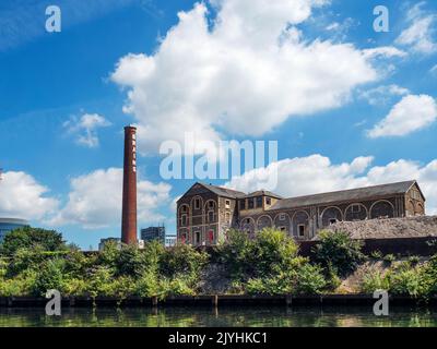 Former Brains brewery building and chimney part of the Central Quay redevelopment in Cardiff Wales Stock Photo