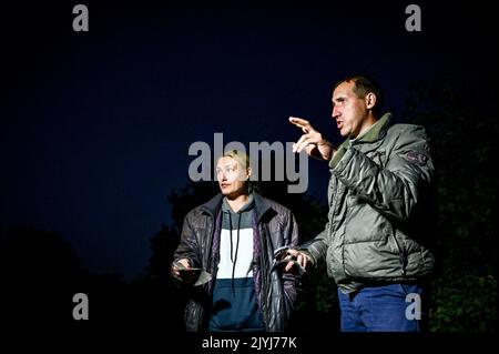 MALA TOKMACHKA, UKRAINE - SEPTEMBER 7, 2022 - Local residents and eyewitnesses Valentyna and Dmytro show the fragments of a rocket to the press after Stock Photo