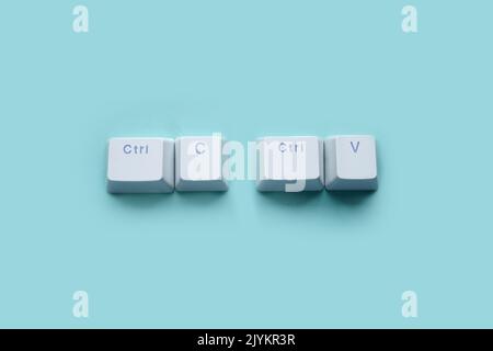 Ctrl C, Ctrl V keyboard buttons, copy and paste key shortcut isolated on a blue background. Stock Photo