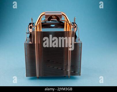 Computer heatsink cooler on blue background. Detail of a personal computer. Stock Photo