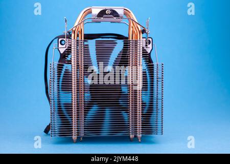 Computer heatsink cooler on blue background. Detail of a personal computer. Stock Photo