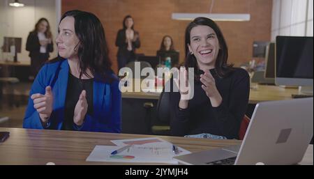 Group of office workers clapping and smiling. Happy People celebrating success at workplace. POV of Colleagues congratulating successful startup lunch Stock Photo