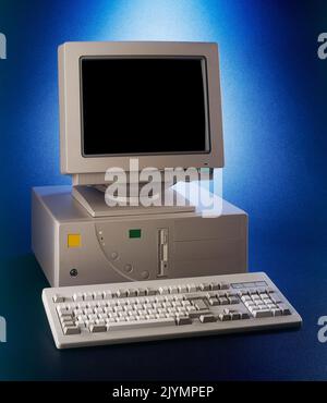 Nineties obsolete tower pc computer on blue gradient background Stock Photo