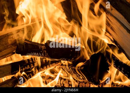 There is a fire blazing in the wood-fired pizza oven with flames erupting from behind it Stock Photo
