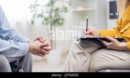 Psychologist making notes Stock Photo
