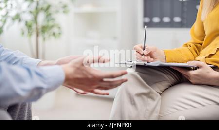 Psychologist doctor making notes Stock Photo