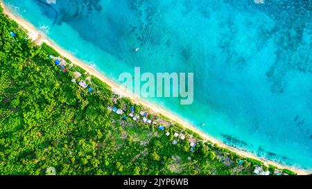 Green & Blue, Aerial view of the fishermen's beach of the M'Tsamboro islet. The contrast between the turquoise blue of the lagoon and the green of the vegetation is striking. The white sand beach marks the passage between these two totally different worlds, Mayotte Stock Photo