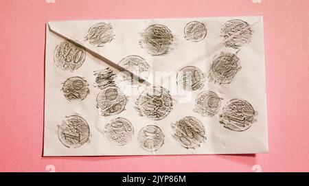 Retrace Euro coin with pencil in envelope isolated on pink background Stock Photo