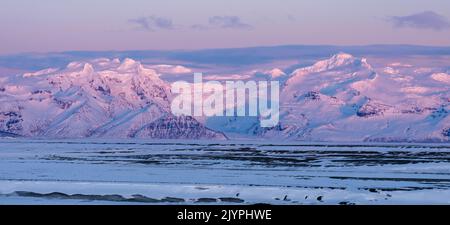 View over the Skeitherarsandur during winter, iceland. View over the Skeitherarsandur during Winter towards Vatnajoekull after sunset. europe, northern europe, iceland, February Stock Photo