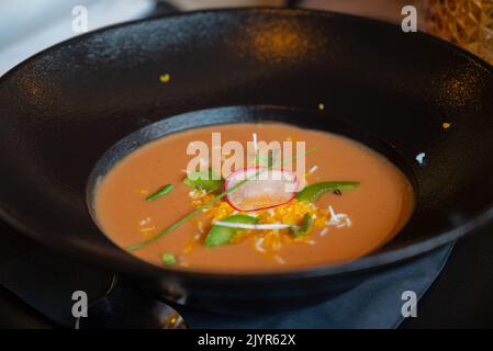 Gazpacho, also called Andalusian gazpacho, is a cold soup and drink made of raw, blended vegetables, served in a black bowl Stock Photo