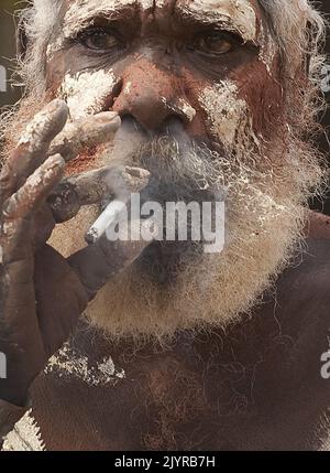 An Aboriginal man smokes a cigarette at a Dance Festival in Laura, north  Queensland, Saturday, June 21, 2009. (AAP Image/Dave Hunt) NO ARCHIVING **  STRICTLY EDITORIAL USE ONLY ** Stock Photo