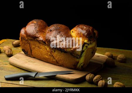 Slices of homemade traditional Romanian sweet bread. Loaf of bread on the table 'cozonac' Stock Photo