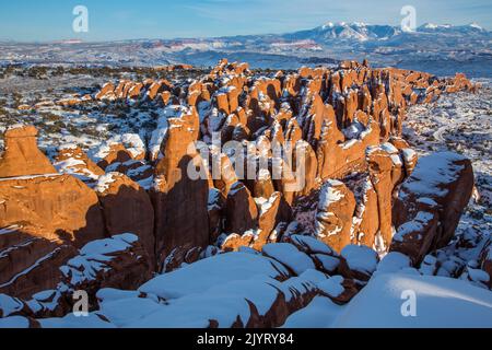 Snow on Fiery Furnace Entranda sandstone fins with snow-capped La Sal Mountains behind.  Arches National Park, Moab, Utah. Stock Photo