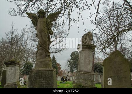 Victorian stone sculptures on a gloomy grey winter day in Kensal Green cemetery in London, UK Stock Photo