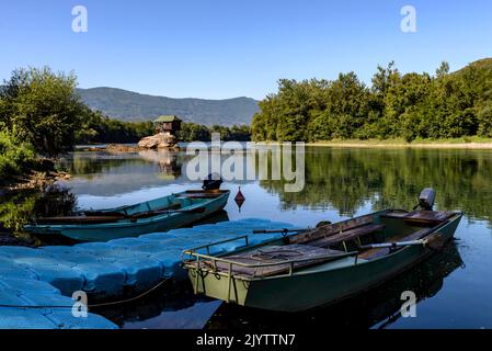 Two fishing boats in front of the famous wooden house on the Drina river in Bajina Basta, Serbia on summer sunny day. Stock Photo