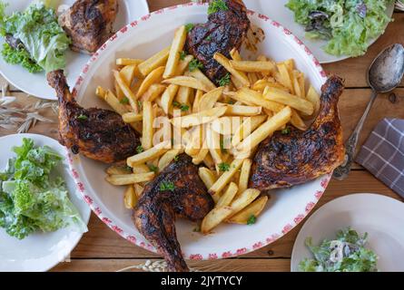 Barbecue chicken legs with homemade french fries. Delicious Family friendly meal Stock Photo