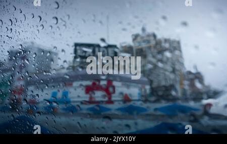 Raindrops falling on glass, abstract blurs - monsoon stock image of Kolkata (formerly Calcutta) city , West Bengal, India Stock Photo