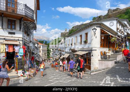 Cobbled street in the historic town centre looking towards Gjirokastra Castle,, Gjirokastra (Gjirokaster), Albania Stock Photo