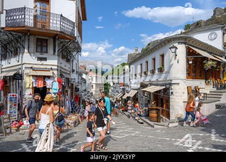 Cobbled street in the historic town centre looking towards Gjirokastra Castle, Gjirokastra (Gjirokaster), Albania Stock Photo