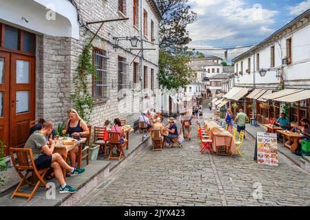 Restaurants on a cobbled street in the historic town centre, Gjirokastra (Gjirokaster), Albania Stock Photo
