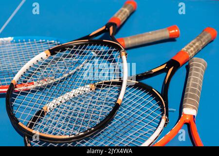 broken tennis rackets on clay tennis court Stock Photo