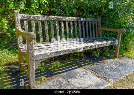 United Kingdom, South West England, Cornwall, Tintagel - The medieval hall-house of 14th century - Rustic wooden garden bench seat in the garden of Th Stock Photo