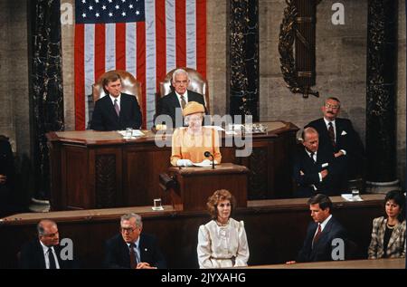 **FILE PHOTO** Queen Elizabeth II Has Passed Away. Queen Elizabeth II of Great Britain addresses a Joint Session of the United States Congress in the US House Chamber in the US Capitol during a State Visit on May 16, 1991. Seated in the rear are US Vice President Dan Quayle, left and Speaker of the United States House of Representatives Tom Foley (Democrat of Washington), right. Credit: Dennis Brack/Pool via CNP /MediaPunch Stock Photo