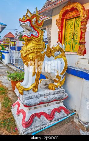 The colored statue of Singha (Chinthe) Lion, located on the grounds of Wat Pa Kham Temple, Pai, Thailand Stock Photo