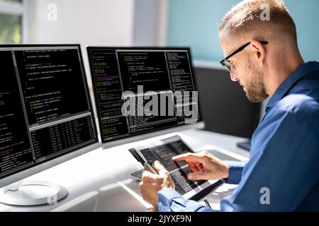 Web Developer Looking At Code. Computer Database Software Programming Stock Photo