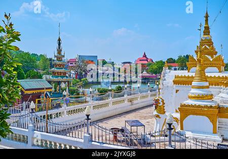 The statue of Chinthe (Singha) lion at the carved white-golden Chedi of Wat Chong Klang Temple, Mae Hong Son, Thailand Stock Photo