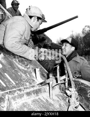 Chiang's Son May Be Tapped - Col. Chiang Ching-Kuo, son of Generalissimo Chiang Kai-Shek, may be among 250,000 nationalist troops trapped in Suchow. A tank corps commander, he is shown (right) talking to a veteran during recent suchow action. August 12, 1948. (Photo by ACME Photo). Stock Photo