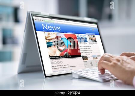 Man Reading News Website On Computer Screen Stock Photo