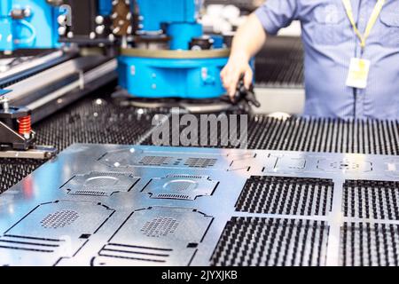 Man working at programmable CNC machine Stock Photo
