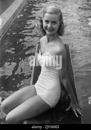 Rose Marie Takes A Cooler -- Barbara Ann Scott star of Rose Marie on Ice, now showing at Harringay Arena, is seen at the 'Oasis' Swimming Pool, Holborn, taking a rest in between shows. July 10, 1951. (Photo by Daily Mirror). Stock Photo