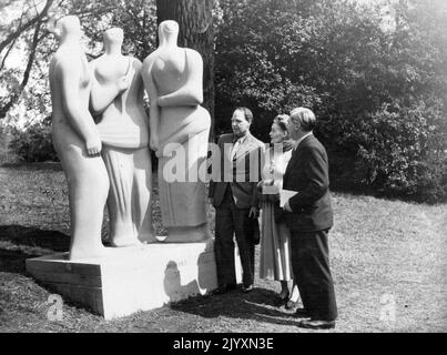 Open-Art Sculpture Exhibition For London -- 'Three Standing Figures', a striking exhibit by Mr. Henry Moore. Inspecting exhibits are Mr. Henry Moore, Mrs. P. Strauss, Chairman of the Parks Committee, and Mr. Aneurin Sevan, Minister of Health. An exhibition of Modern Sculpture has now been opened in Battersea Park, London, under the auspices of the London County Council and many of the exhibits are causing intense interest among the visiting Londoners. May 13, 1948. (Photo by Sport & General Press Agency Limited). Stock Photo