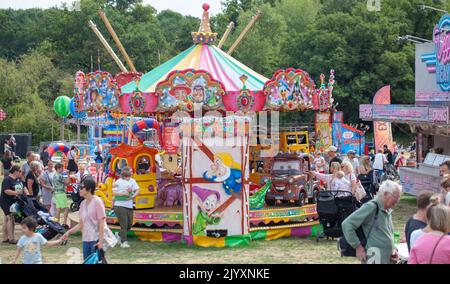 Chelmsford, Essex, Britain, 2022 Families Enjoying Fair at Hylands Park Funfair with Traditional Carousel fairground rides. Stock Photo