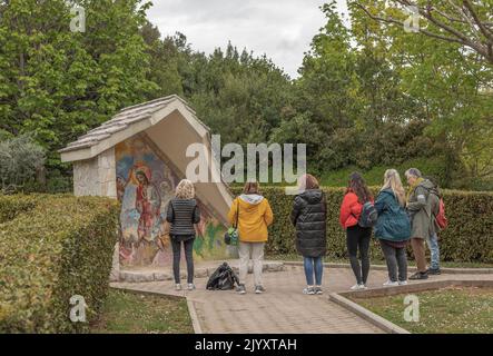 Medjugorje, Bosnia and Herzegovina - April 23rd 2022 - Tourists visit the important religious town of Medjugorje and pause for a moment by the mosaic Stock Photo