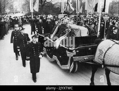 Princess follow coffin of Gustav Adolf - Killed in air crash - as body is taken home with military honours Picture shows:- The coffin passing through a crowd-lined street of Copenhagen escorted by naval officers and followed by - left to right - Crown Prince Frederick of Denmark; Prince Wilhelm of Sweden and Sigvard Bernadotte, brother of the dead Prince Royal mourners followed the coffin as, with military honours, the body of Prince Gustav Adolf of Sweden - One of 22 parsons killed in a Dutch Dakota airliner which crashed at Kastrup, Denmark, as it was leaving for Sweden - was taken on horse- Stock Photo