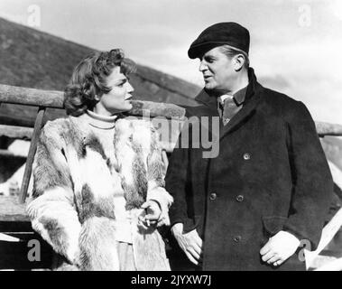 SIMONE SIGNORET and JACK WARNER on set location candid during filming of AGAINST THE WIND 1948 director CHARLES CRICHTON producer Michael Balcon Ealing Studios / General Film Distributors (GFD) Stock Photo